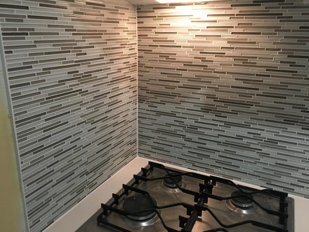 Glass mosaic tiling around kitchen hob
